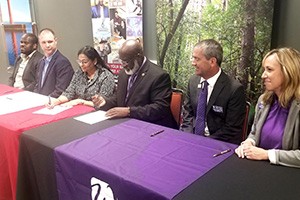 Representatives of Gateway and UW-Whitewater signing transfer agreement