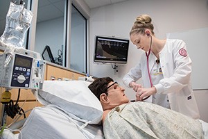 Nursing student practicing in lab