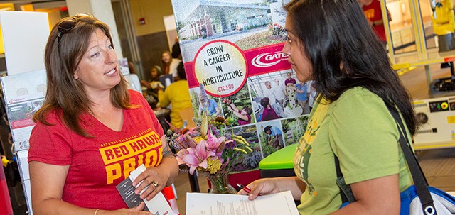 Student getting information at an Open House event