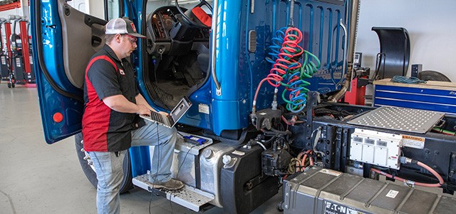 Apprentice working on diesel truck