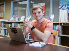 Jacob Ward at a desk with a laptop