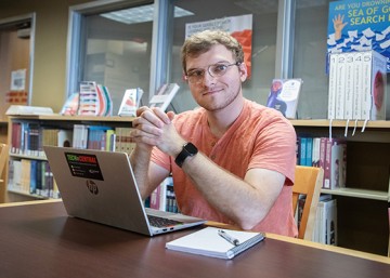 Jacob Ward at a desk with a laptop