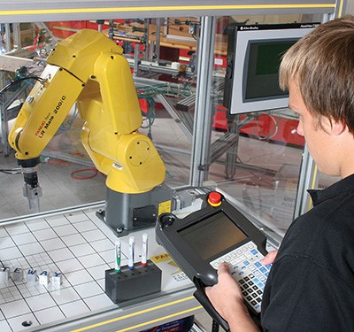 Student operating robotic arm