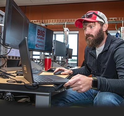 IT Student at computer workstation