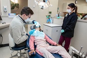 Dental Hygienist student performing cleaning under supervision